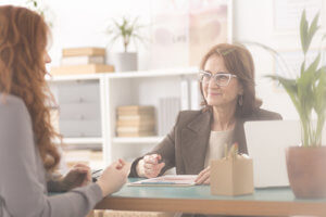 a woman talks to a counselor at a women's eating disorder treatment center